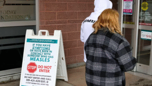 two persons walking into a pharmacy